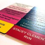 A display of personalised Engraved Coloured Acrylic Name Badges, featuring a spectrum of colours for a lively and professional touch
