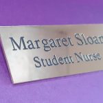 Polished rectangle brass name badge, featuring black engraved text