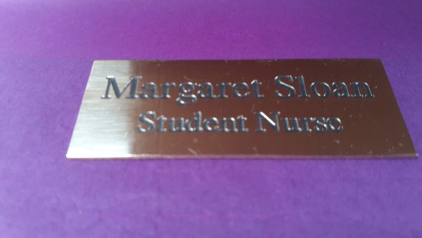 Polished rectangle brass name badge, featuring black engraved text