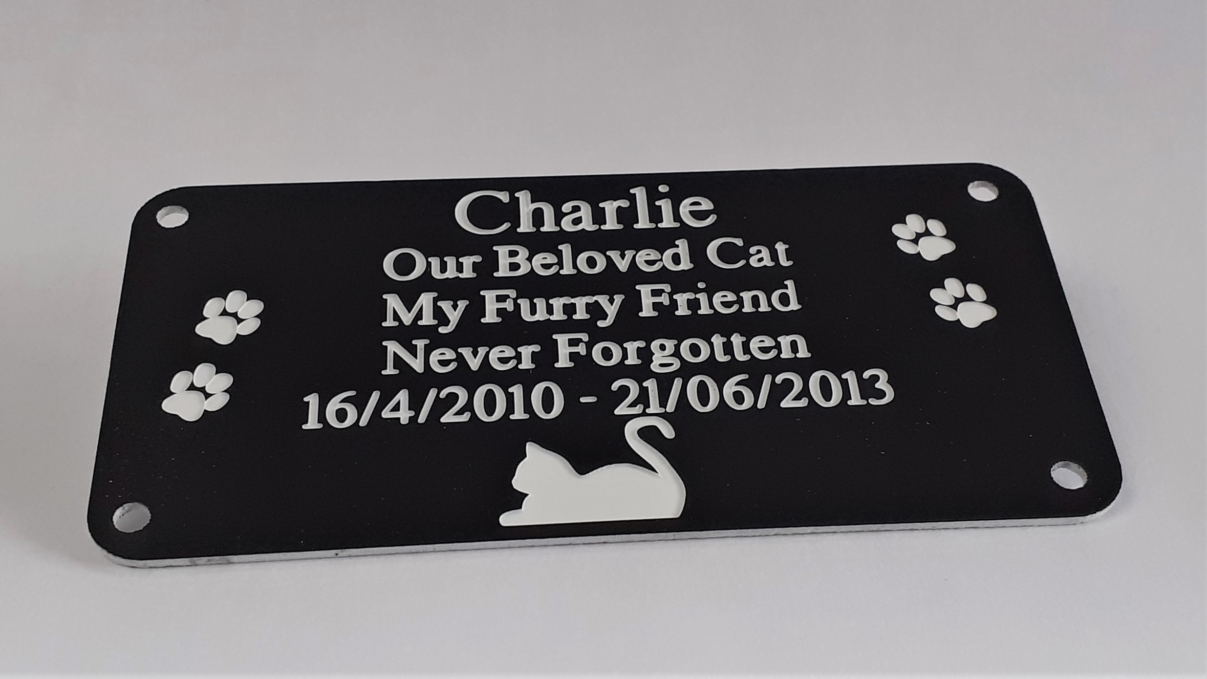 Close-up of a 4" x 2" Pet Memorial Engraved Dog Plaque with Paw Prints.