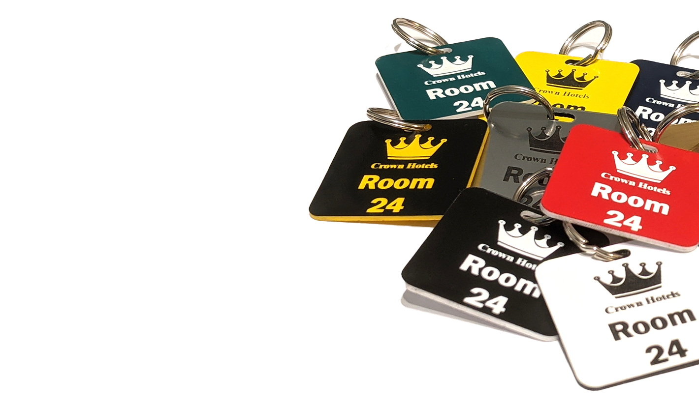 Keyrings showing a crown logo and a door number on in contrasting colours