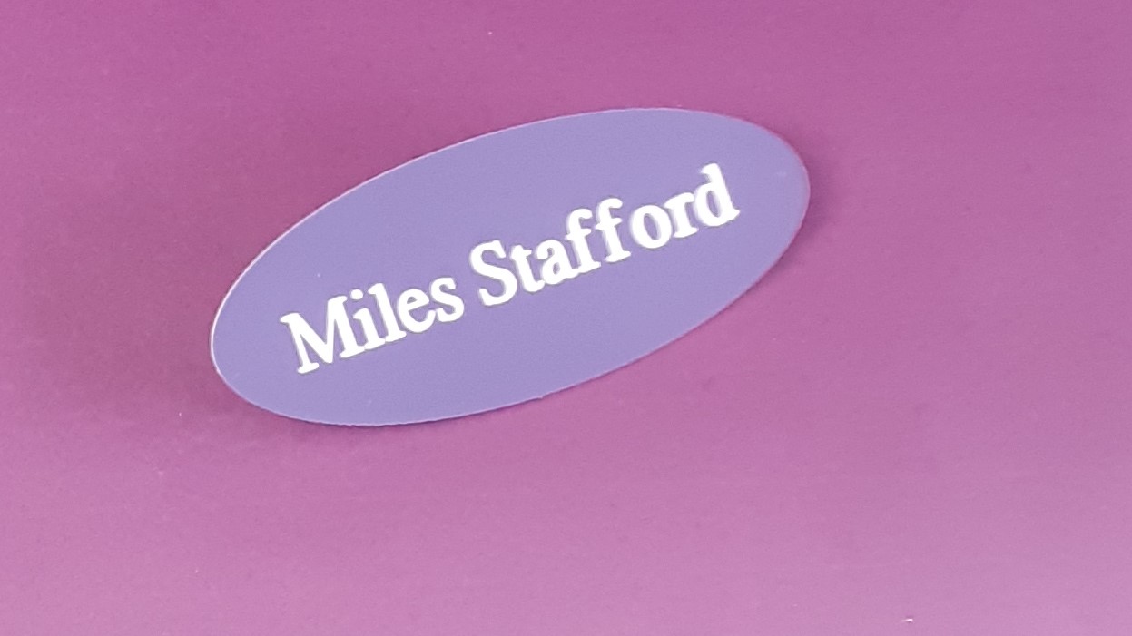 Engraved purple oval name badge, engraved with white text.