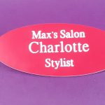 Engraved red oval name badge, engraved with white text.