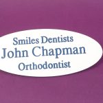 Engraved white oval name badge, engraved with blue text.