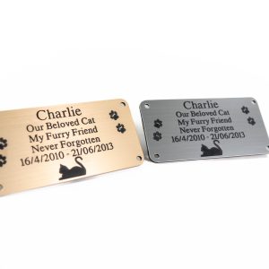Silver and gold rectangle plaques with black engraving and rounded corners and four screw holes
