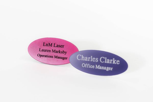 Oval-shaped acrylic engraved name badges in a range of vibrant colours. These badges are made from durable acrylic material