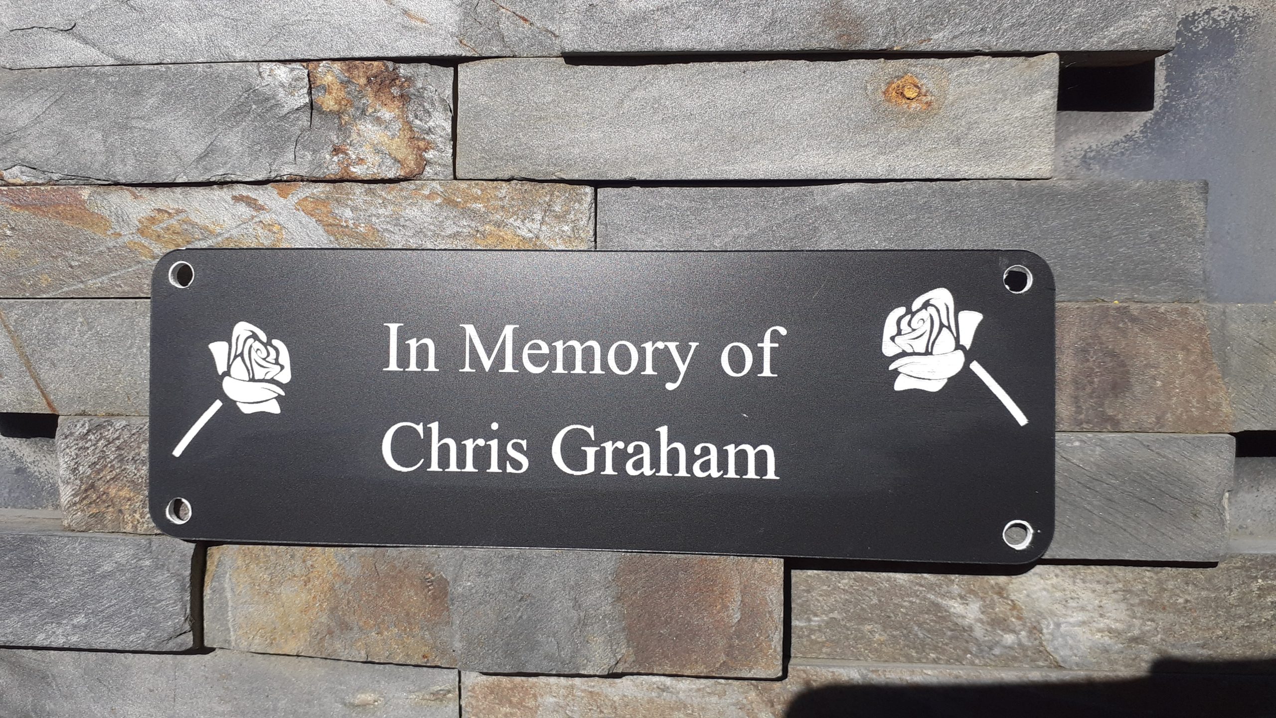 Personalised bench Plaques - 6" x 2" with decorative roses either side of the white engraved text, 4 screw holes in each corner.