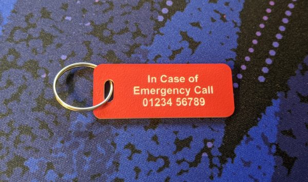 Bright red emergency tag indicating medical conditions for quick identification and assistance.