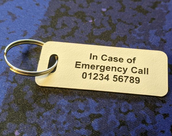 White emergency tag, easily noticeable, providing critical medical details in case of emergencies