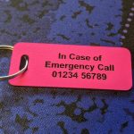 Pink emergency tag, combining visibility and essential medical information for emergency responders.