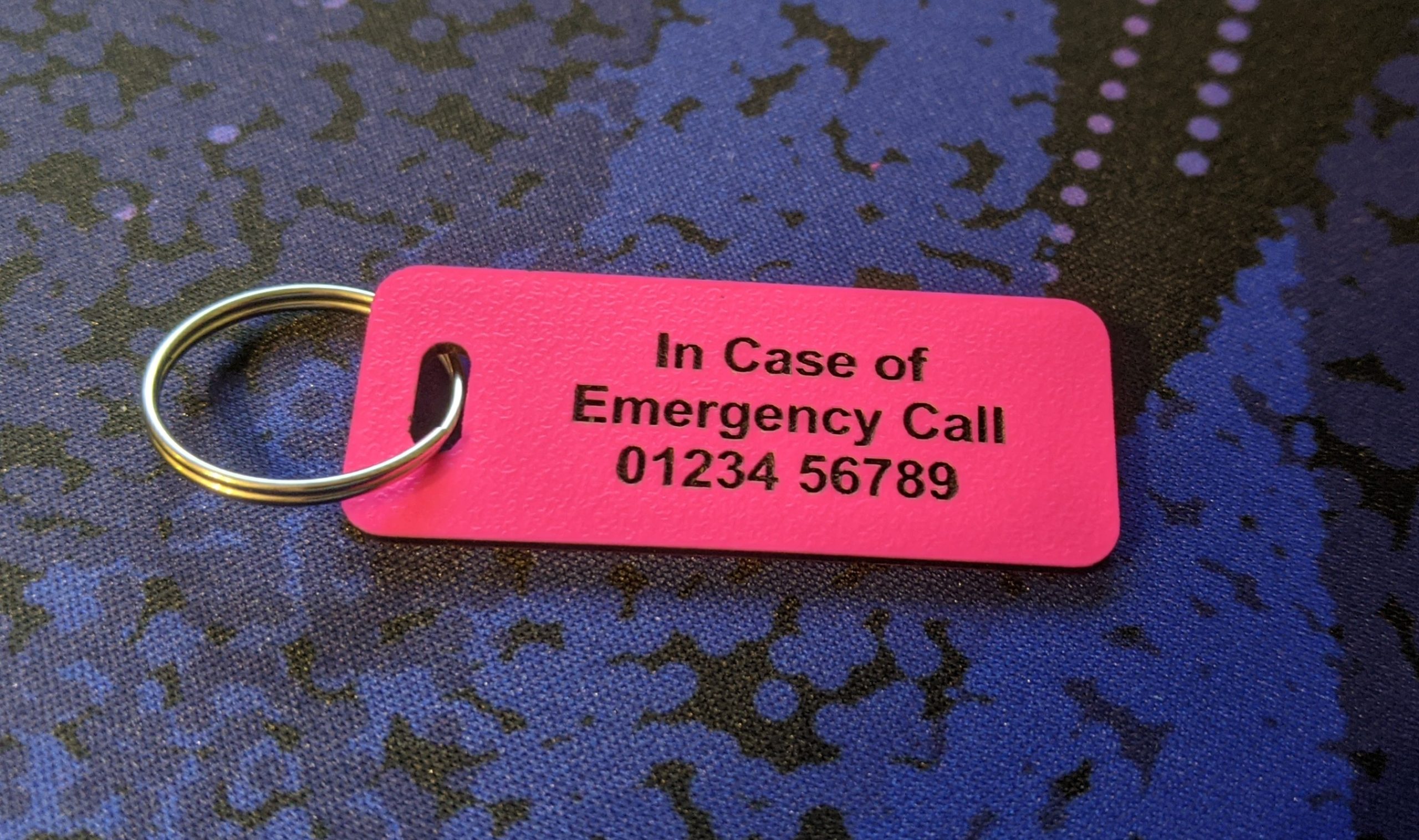 Pink emergency tag, combining visibility and essential medical information for emergency responders.