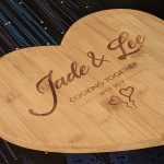 Personalised heart bamboo cutting board featuring Jade and Lee's culinary journey since 2019 with two charming love hearts.