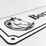 Close up of black Engraving on White Stable Name Plaque - 6" x 2" with Left-Hand Horse's Head Design
