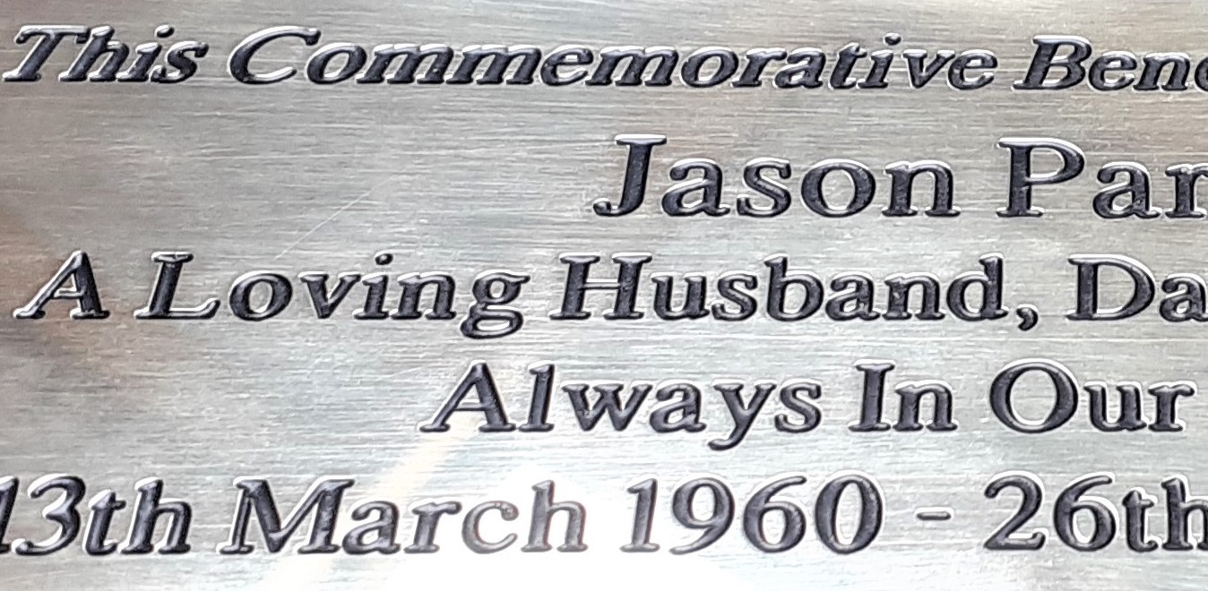 Close up of text of a brass plaque