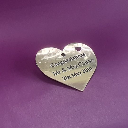 Elegantly engraved brass heart-shaped keepsake.