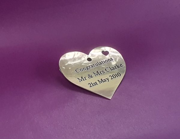 Elegantly engraved brass heart-shaped keepsake.