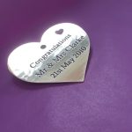 brass heart plaque with black infill, featuring a delicate small heart in the upper right corner.