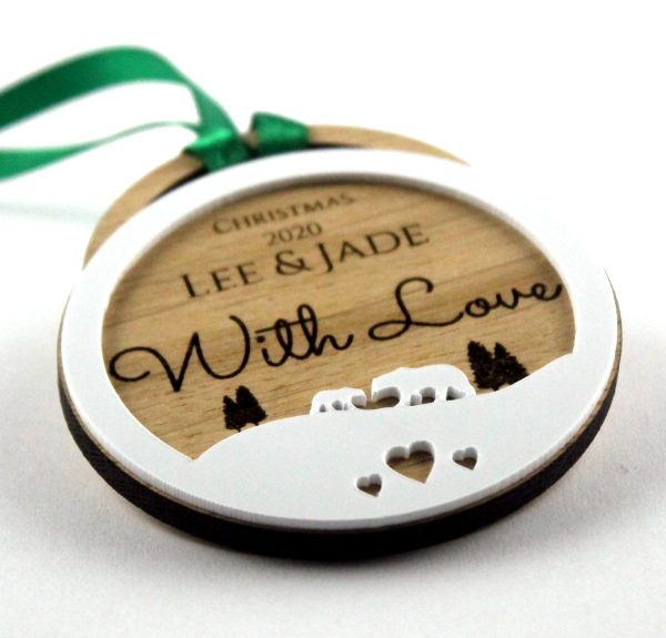 Each wooden ornament features intricate engravings, including family names, special messages, and memorable dates. They hang gracefully from the tree branches, adding a rustic and sentimental touch to holiday decorations.