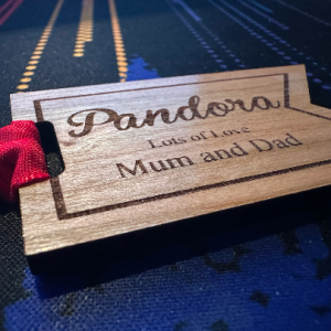 Eco-friendly cherry wood gift tag personalised for Christmas, featuring engraved design