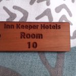 Wooden keyring featuring detailed engraving, accompanied by a supplied split ring