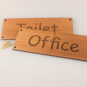 6 inch by 2 inch personalised wooden door signs with screw holes and brass screws scaled