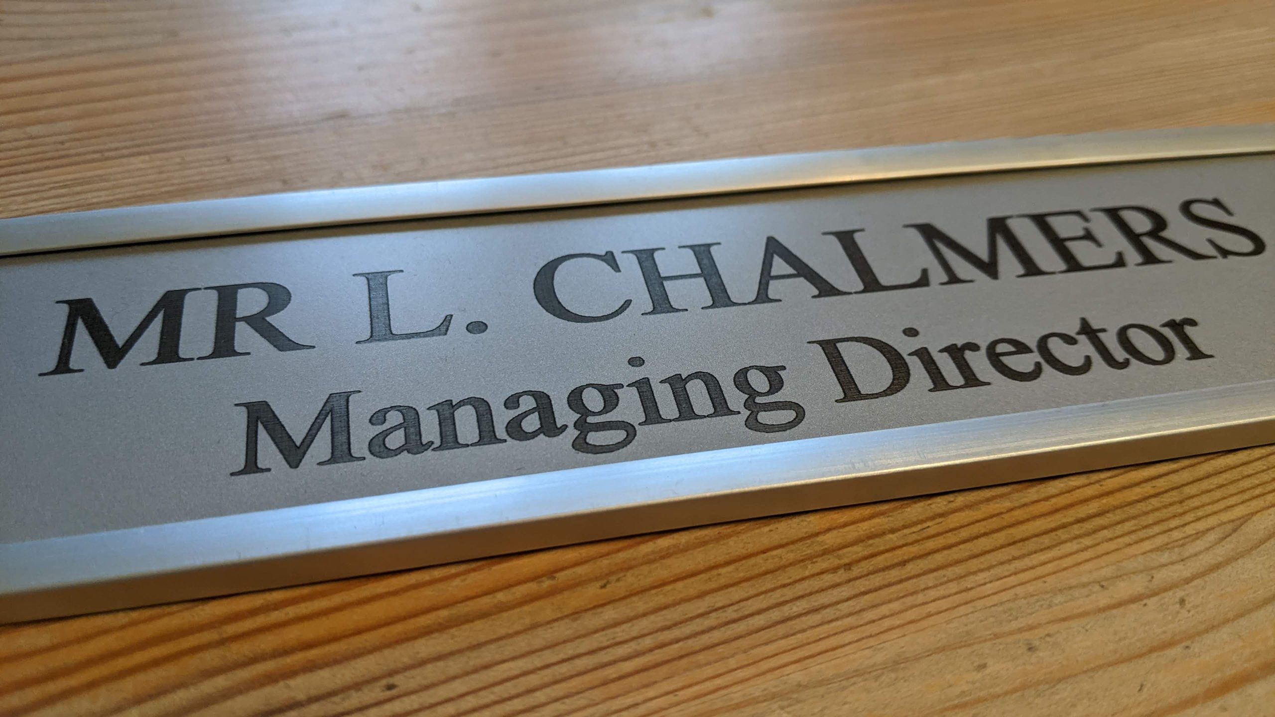 Make a statement at your office entrance - 10" x 2" aluminum door sign displayed in contemporary aluminum holder.