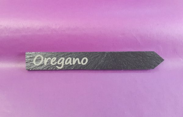Personalised slate plant markers with custom engraving showing Oregano