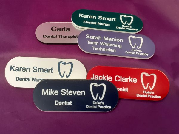 A collection of vibrant and diverse name badges, each uniquely coloured in shades