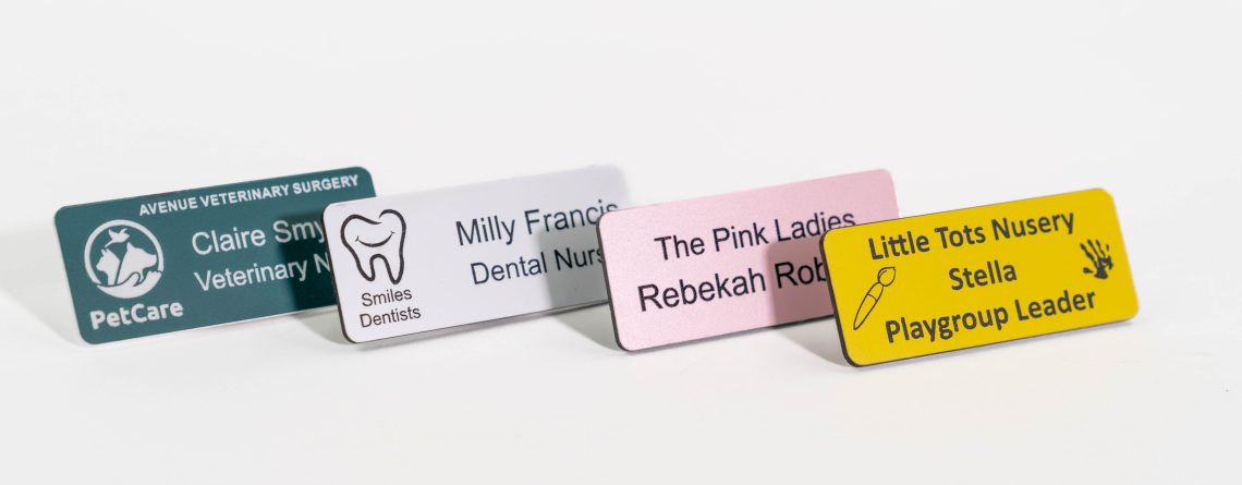 Multiple Name Badges aligned next to each other with logos just text and different colours.