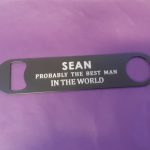 Stainless steel Bar Blade Bottle Opener with laser engraved text, showing the best man and a person name
