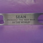 Stainless steel Bar Blade Bottle Opener with laser engraved text, showing the best man and a person name