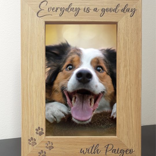 Pet Memorial Photo Frames 7" x 5" An oak veneer photograph frame. It has been personalised with text etched on the frame, with the dog’s name at the top of the frame, forever missed at the bottom, 4 paw prints etched in the bottom left-hand side of the frame, a heart top right