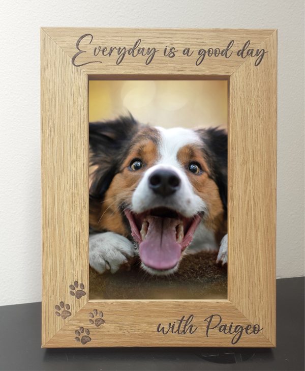 Pet Memorial Photo Frames 7" x 5" An oak veneer photograph frame. It has been personalised with text etched on the frame, with the dog’s name at the top of the frame, forever missed at the bottom, 4 paw prints etched in the bottom left-hand side of the frame, a heart top right