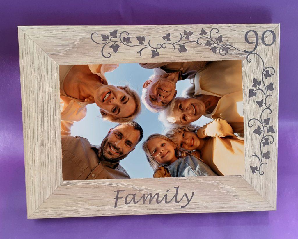 Personalised Engraved 4"x6" Photo Frames, An oak veneer photograph frame. It has been personalised with text etched on the frame showing a picture of a group of adults looking down