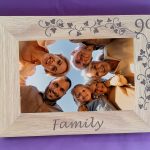 Personalised Engraved 4"x6" Photo Frames, An oak veneer photograph frame. It has been personalised with text etched on the frame showing a picture of a group of adults looking down