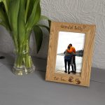Personalised Engraved 4"x6" Photo Frames, An oak veneer photograph frame. It has been personalised with text etched on the frame showing a picture of a man and woman