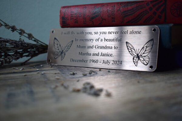 Bronze Bench Plaque on a purple background showing 2 butterflies either side of text and supplied with 4 screw holes