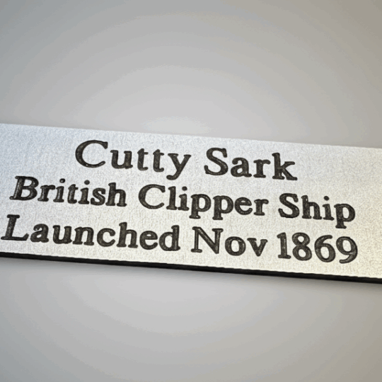 A 75mm x 25mm aluminium plaque with the text 'Cutty Sark British Clipper Ship Launched Nov 1869' on a subtle grey gradient background